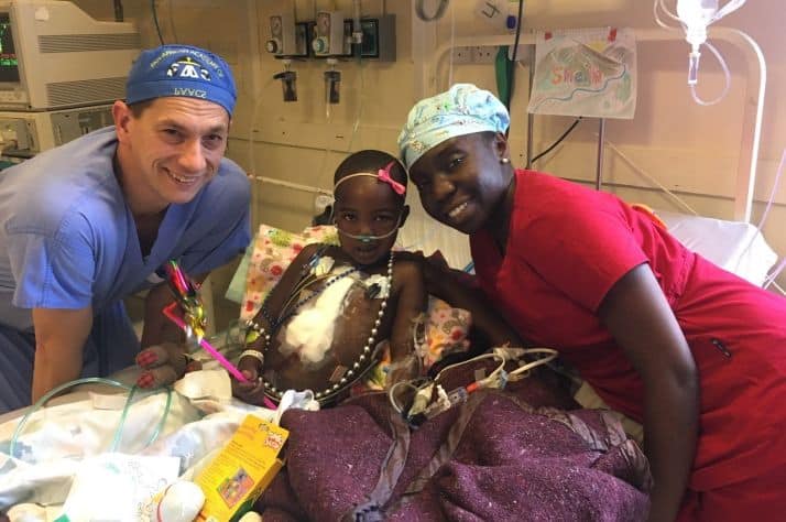Dr. David Horne celebrates a successful open-heart procedure with one of his young Kenyan patients and Dr. Agneta Odera, a surgeon at Tenwek Hospital.
