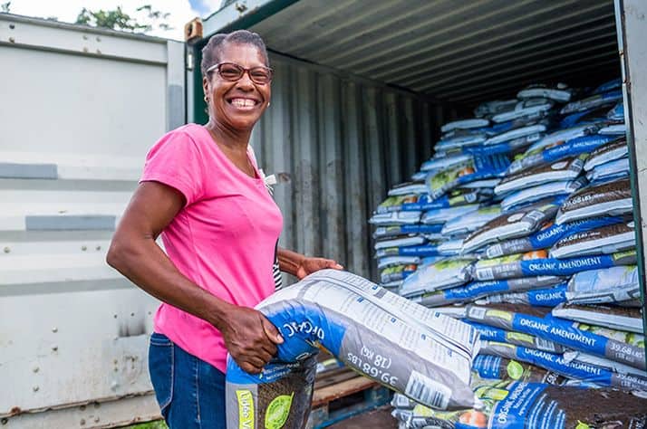 Gilles unloads fertilizer from Samaritan’s Purse to aid her crops.