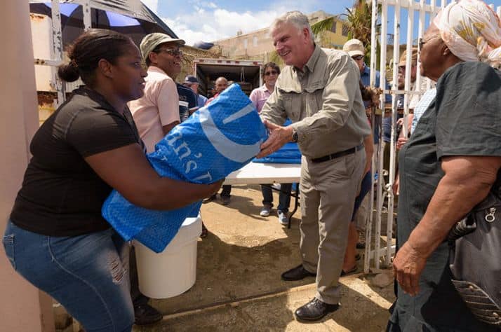 Samaritan's Purse International President helps distribute heavy-duty shelter plastic in Puerto Rico on Monday.