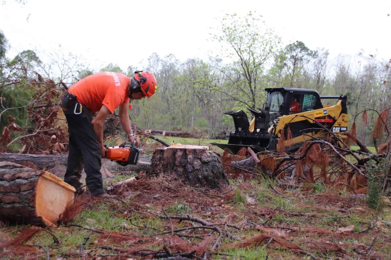 Canadian volunteers, Phil Pavel and Harold Helm, removing debris for a homeowner in Mexico Beach.