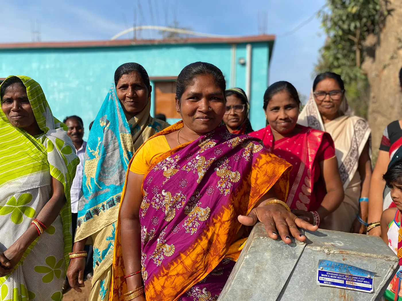 Children and families in a community supported by safe water projects and Gospel-centered care.