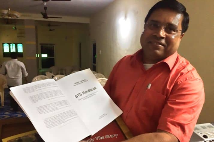 An instructor shows off a lesson plan that is used to equip and encourage pastors.