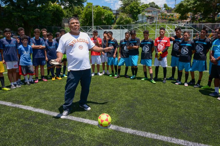 Soccer balls are helping open doors to some of the most violent, gang-controlled neighborhoods in the world. Pictured above: One of our partners shares the Gospel before a youth soccer match in El Salvador.