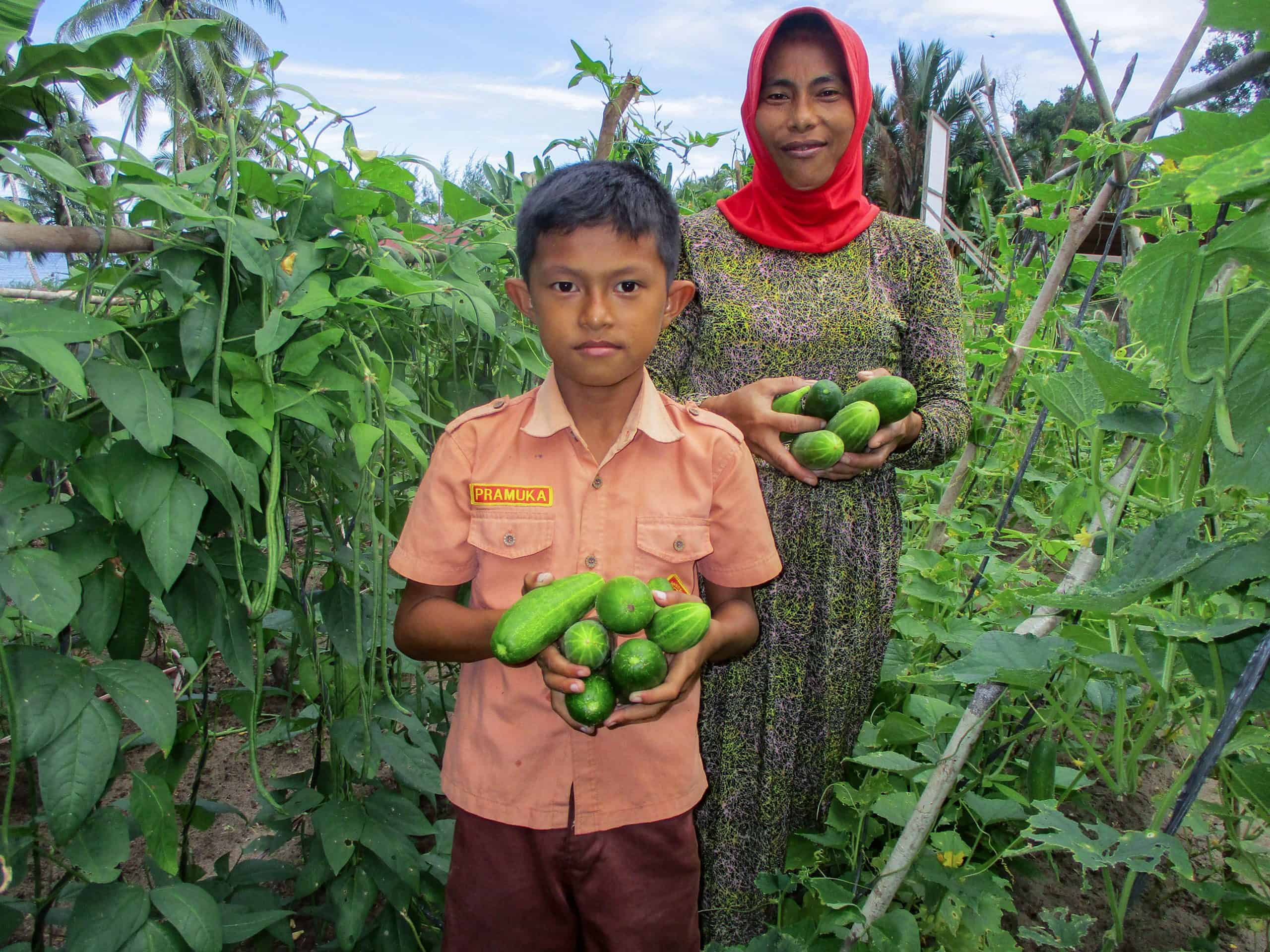 Mama Widia and her son with cucumbers