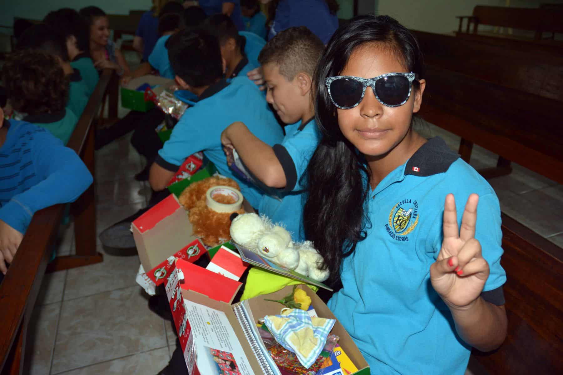 This girl in Costa Rica was excited to find new sunglasses in her gift-filled shoebox.