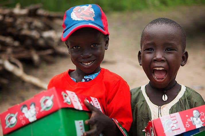 Children open their Operation Christmas child shoeboxes, packed by generous Canadians like you.
