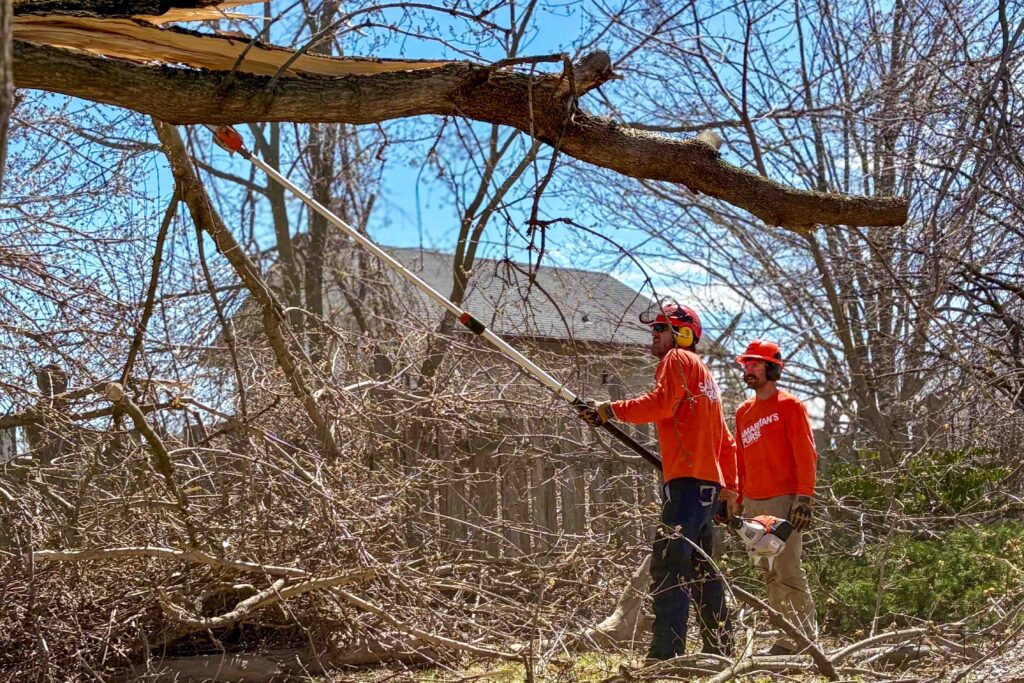 Two volunteers clearing debris from a home.