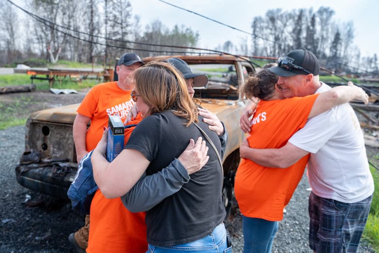 Cory and Meredith receive a Bible from the Samaritan's Purse team.