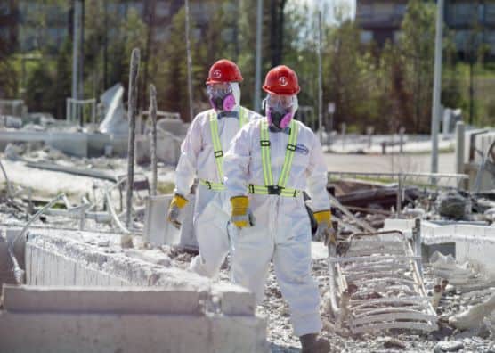 Two volunteers in rubble