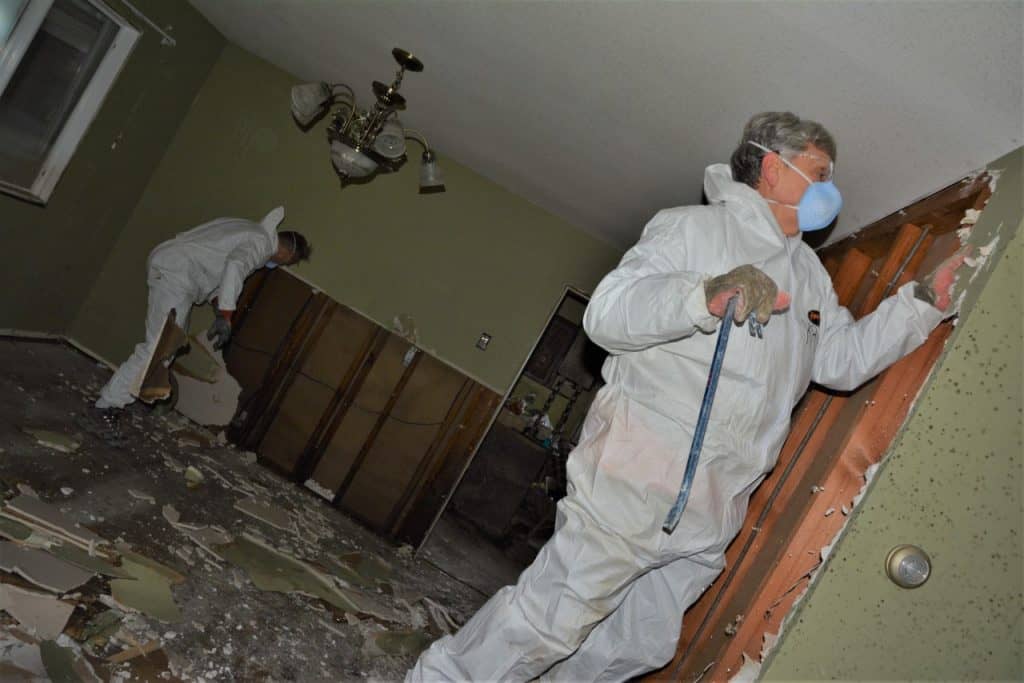 Samaritans Purse volunteers ripping out drywall in a B.C. home after flash floods in November. 
