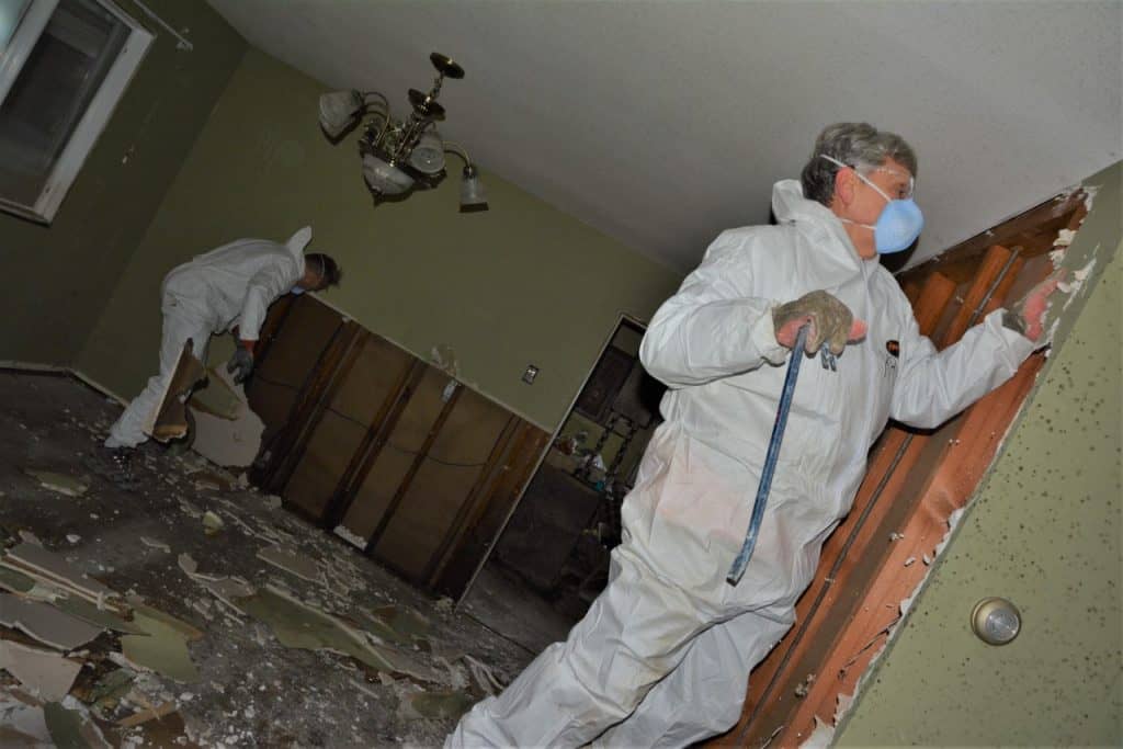 Samaritans Purse volunteers ripping out drywall in a B.C. home after flash floods in November.