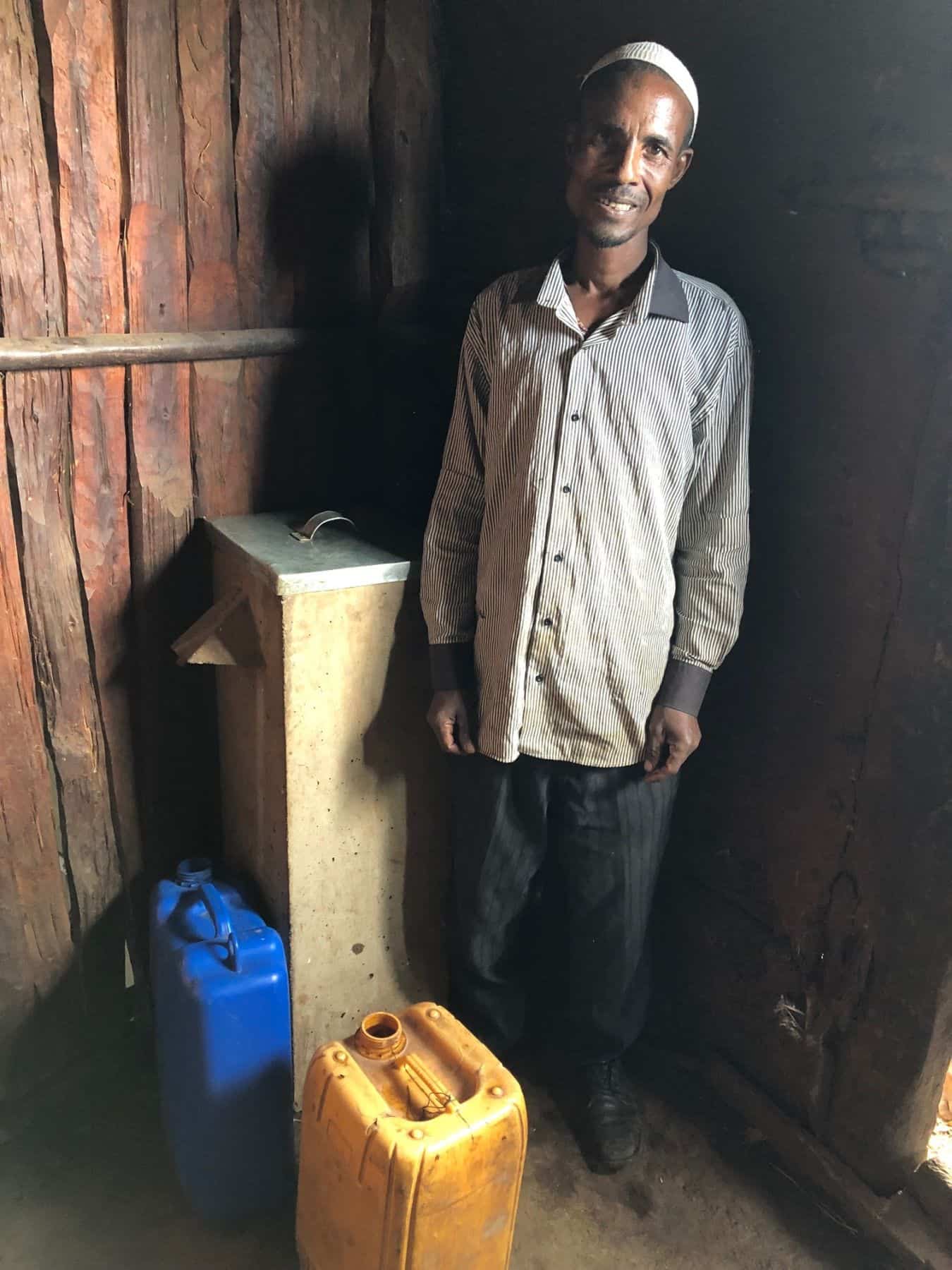 Sefa Nassir beside his life-saving BioSand Filter.