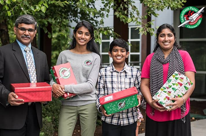 Raja, Giftlin, Jonathon, and Ramya delight in packing shoeboxes now to bless others the way they had been blessed.