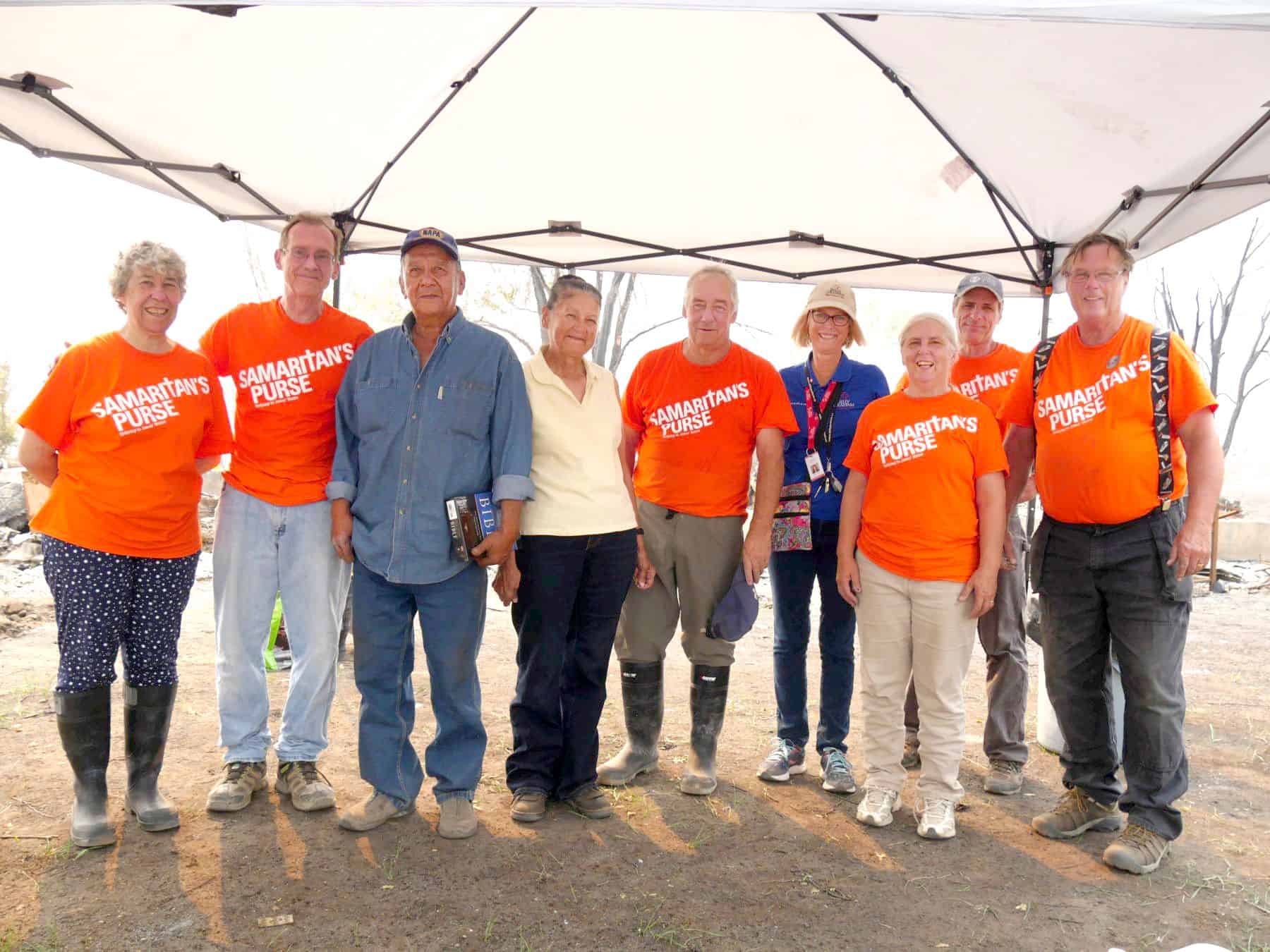 Ruth and her husband Les, pictured here with Samaritan's Purse volunteers and Billy Graham Rapid Response Team chaplains (pictured in blue), lost virtually everything they owned in the wildfire surrounding Ashcroft, BC.