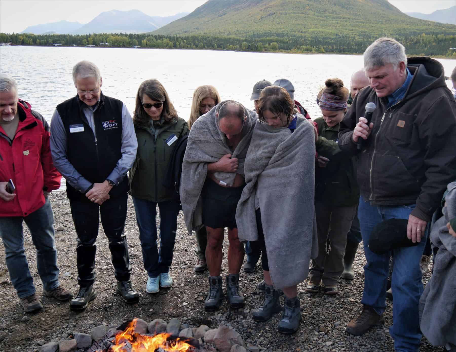 After six people were baptized in the chilly waters of Lake Clark, Samaritan's Purse international president Franklin Graham prayed with them to encourage them in their new faith.