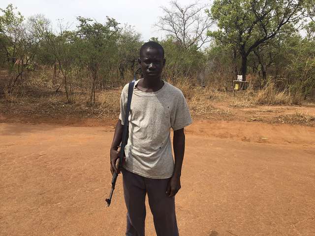 Bearing a Kalashnikov assault rifle, a soldier from the South Sudanese Liberation Army stood guard near South Sudan’s border with Uganda. Matthew Fisher / Postmedia News