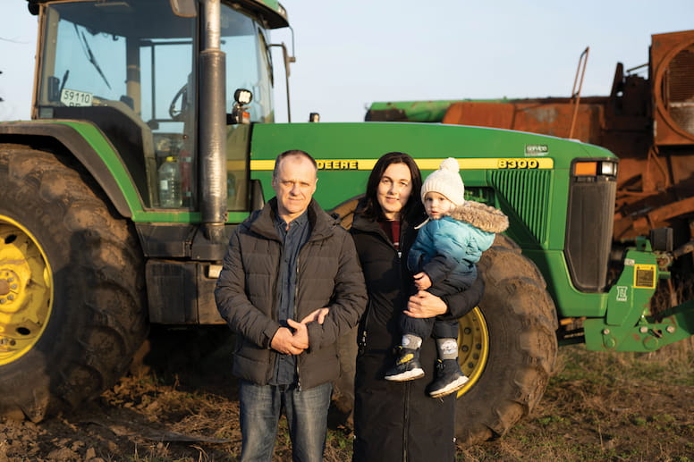 Oleksiy and his family with tractor