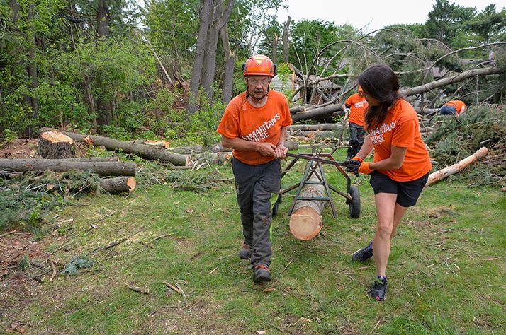 Armed with chainsaws and a skid steer, teams of volunteers helped clear properties of damaged trees that were at risk of falling.