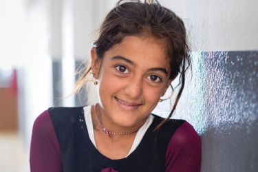 Simple resources like safe latrines and clean water help young girls stay at school.