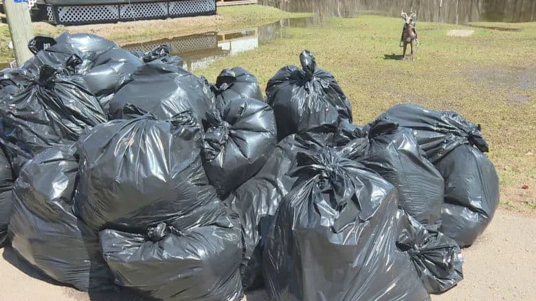 Samaritan's Purse bagged gathered about 50 bags of soaked insulation from underneath Earl Leblanc's mobile home. (Shane Fowler/CBC)